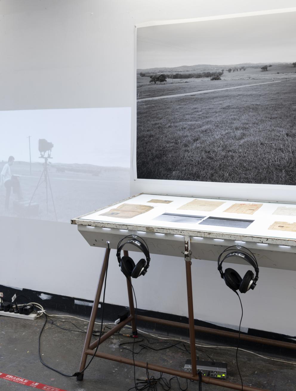 Mixed media installation consists of moving image, sound, family archive documents, photograph, and negatives.