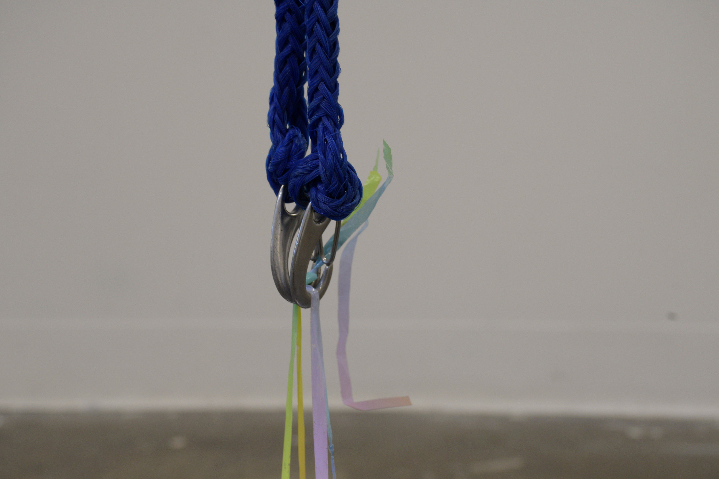 'In waves', 2024. Earthenware and glaze, unfired BRT, gift wrap ribbon, carabiners, nylon rope.