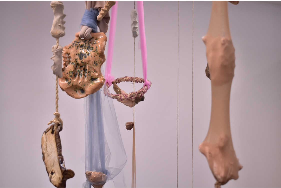 'Hold on me', 2024. Raw, fired glazed and unglazed earthenware, resin, wire, tulle, jute twine, panty-hose
