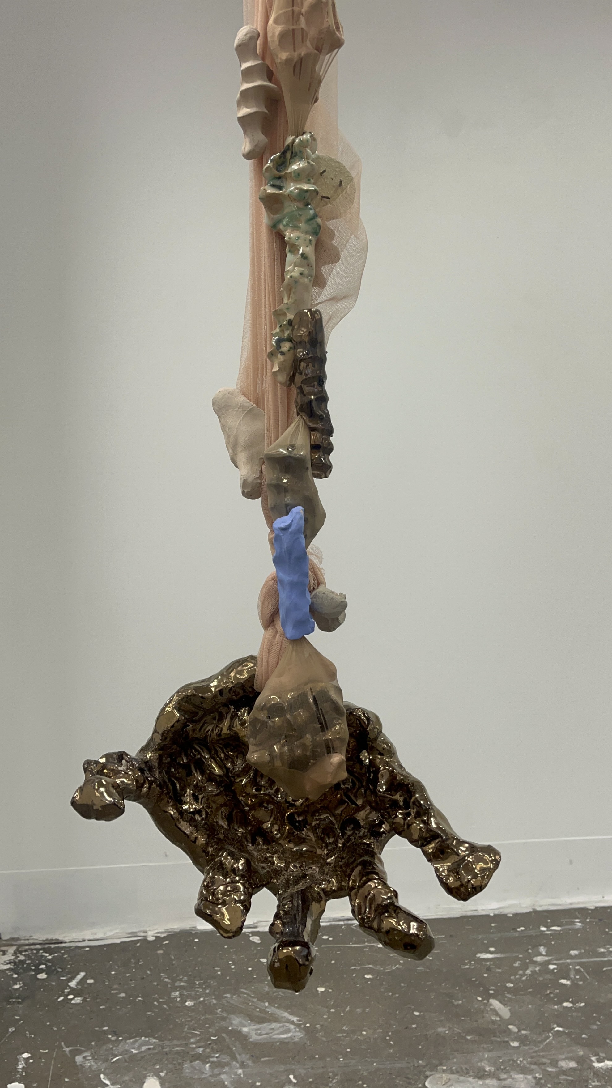 'Hold on me', 2024. Glazed and raw earthenware, panty-hose, tulle