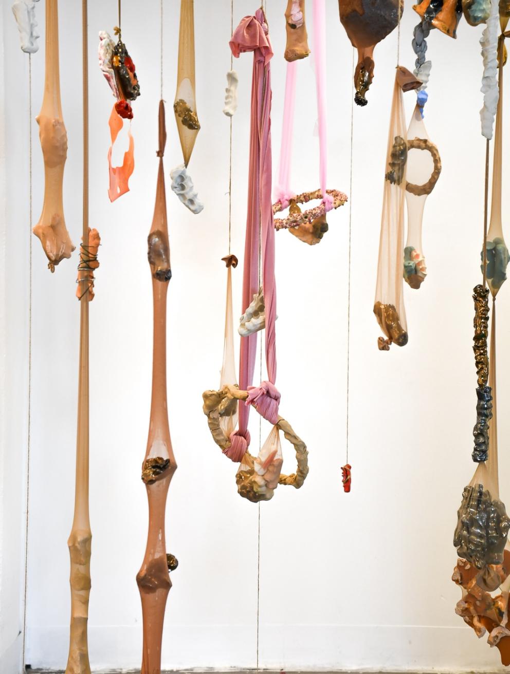 'Hold on me', 2024. Raw, fired glazed and unglazed earthenware, resin, wire, tulle, jute twine, panty-hose