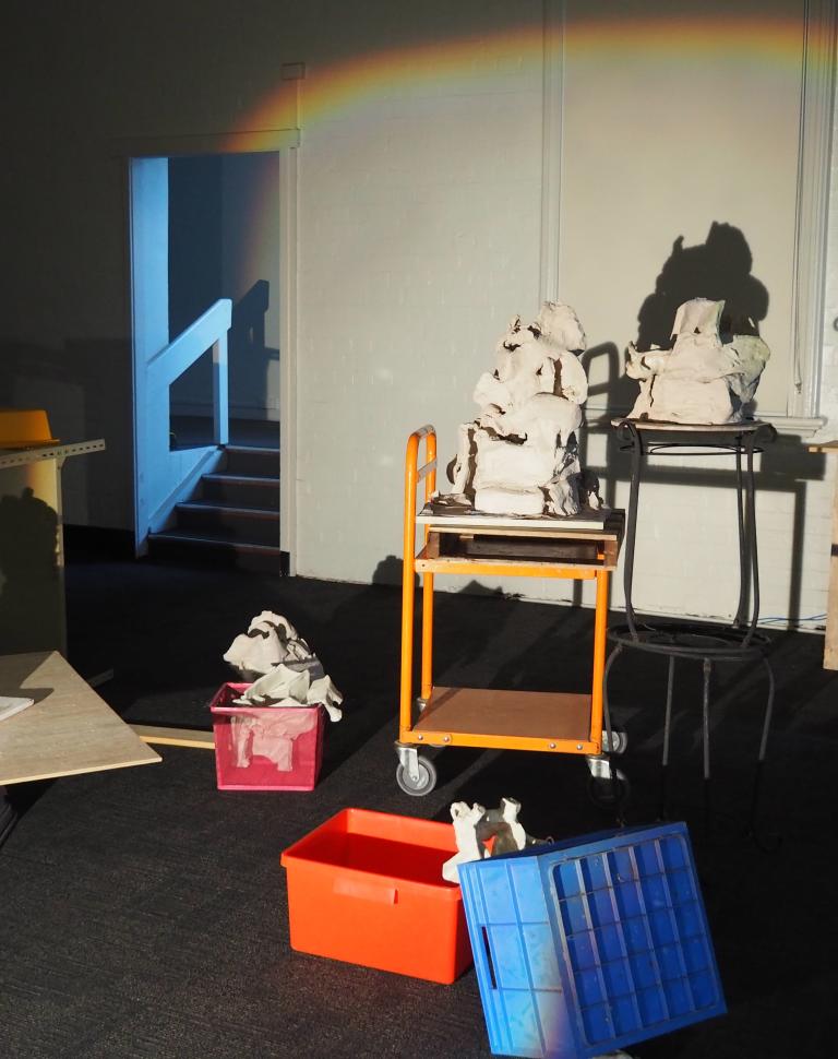Recycled clay (unfired and fired), coloured slip, glaze, ceramic studio trolley, kiln props, kiln shelf, wood, found objects (from family home), zines; printer paper, printer ink, polyester thread, movie stills