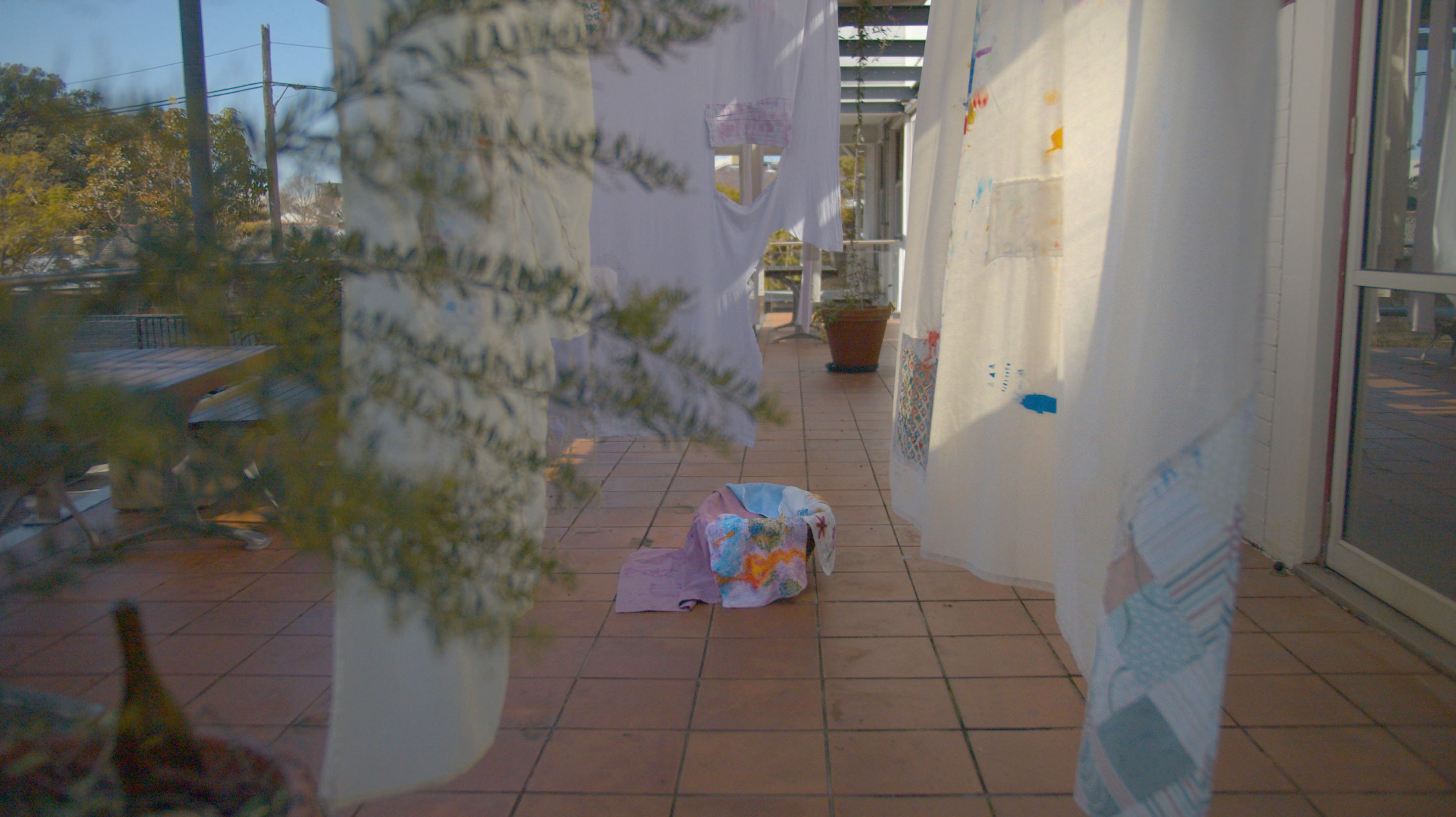 'I will hold you (and all your frayed edges)', 2025. Installation, used bedsheets, poetry, conversation, embroidery, fabric paint.