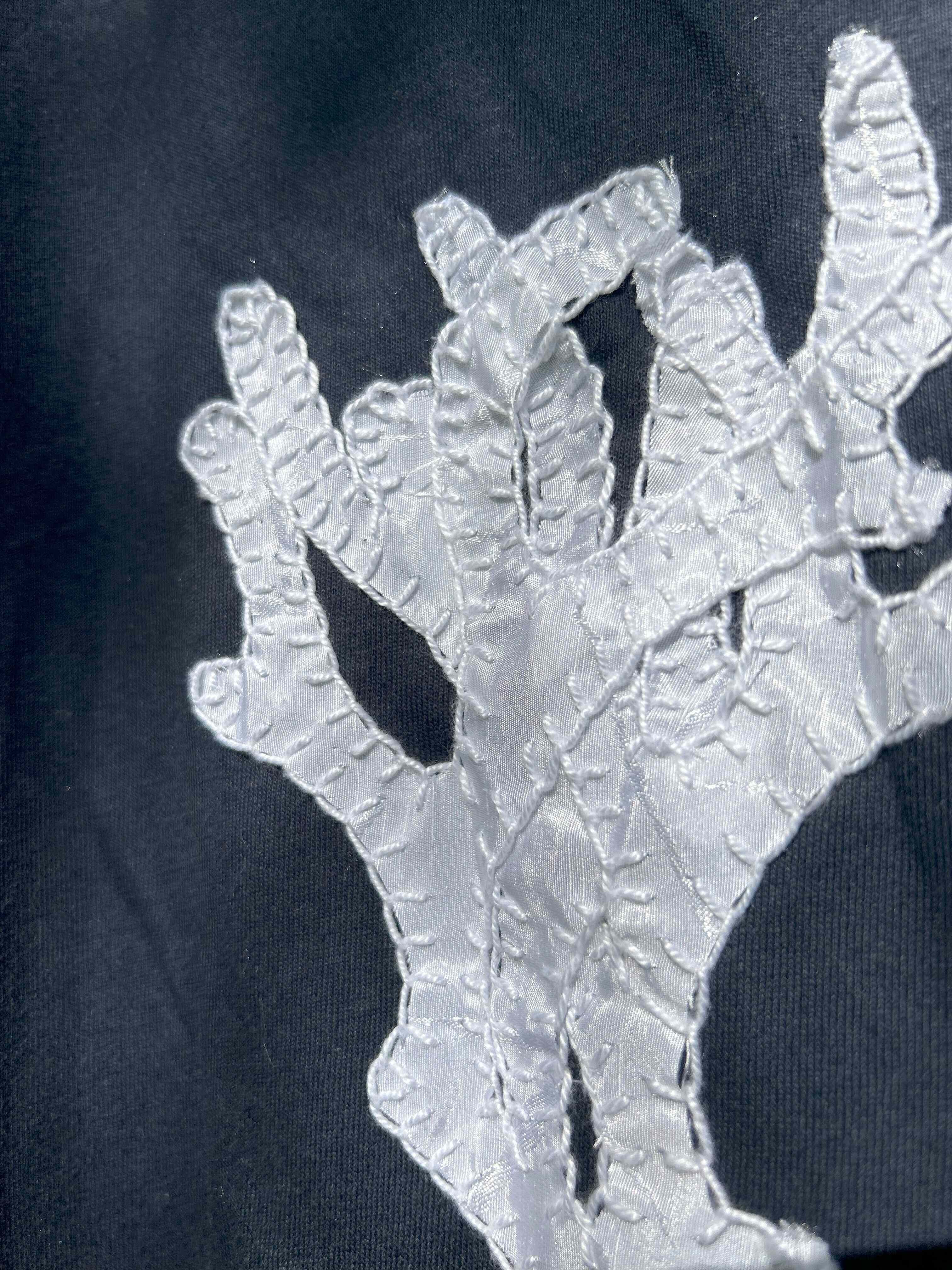 'Coral Bleaching T-shirt', 2025. Fabric scrap design and cotton t-shirt