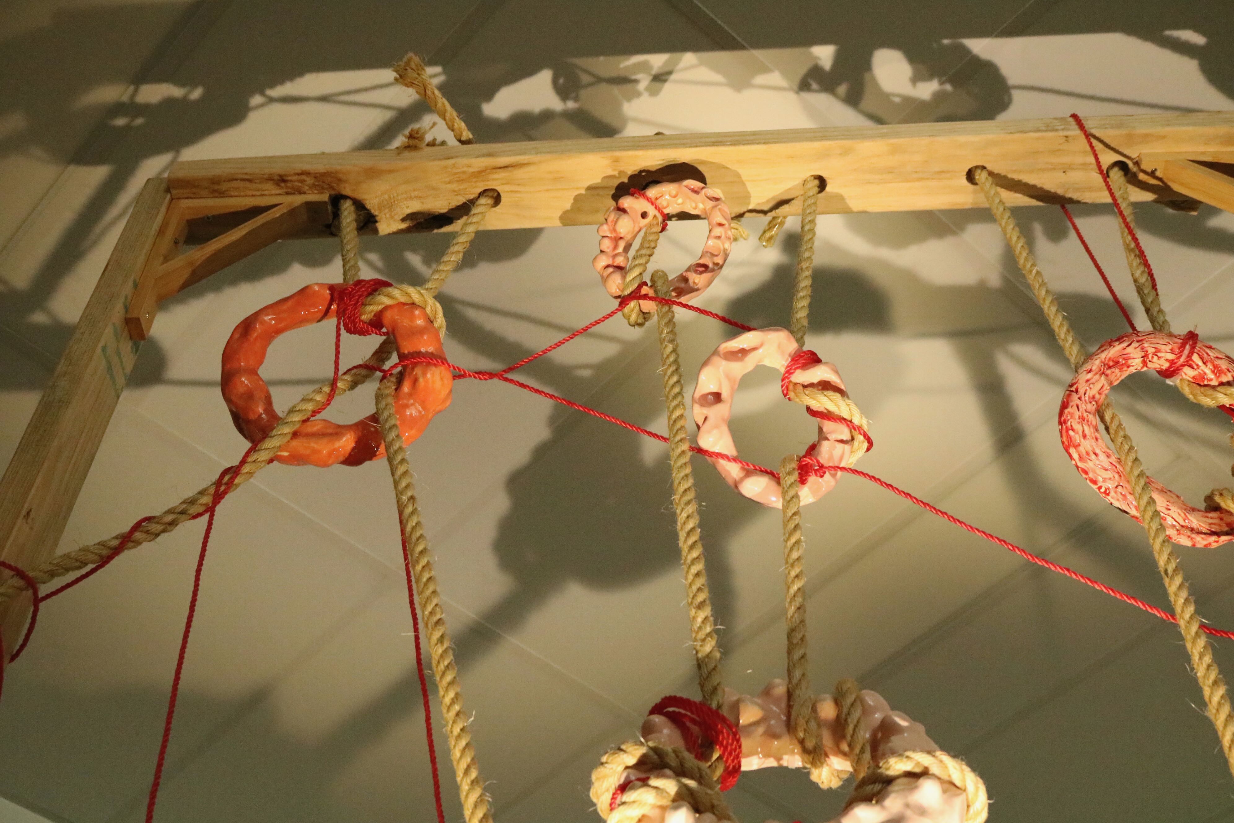 'Fleshscape', 2025. Glazed earthenware, rope, timber