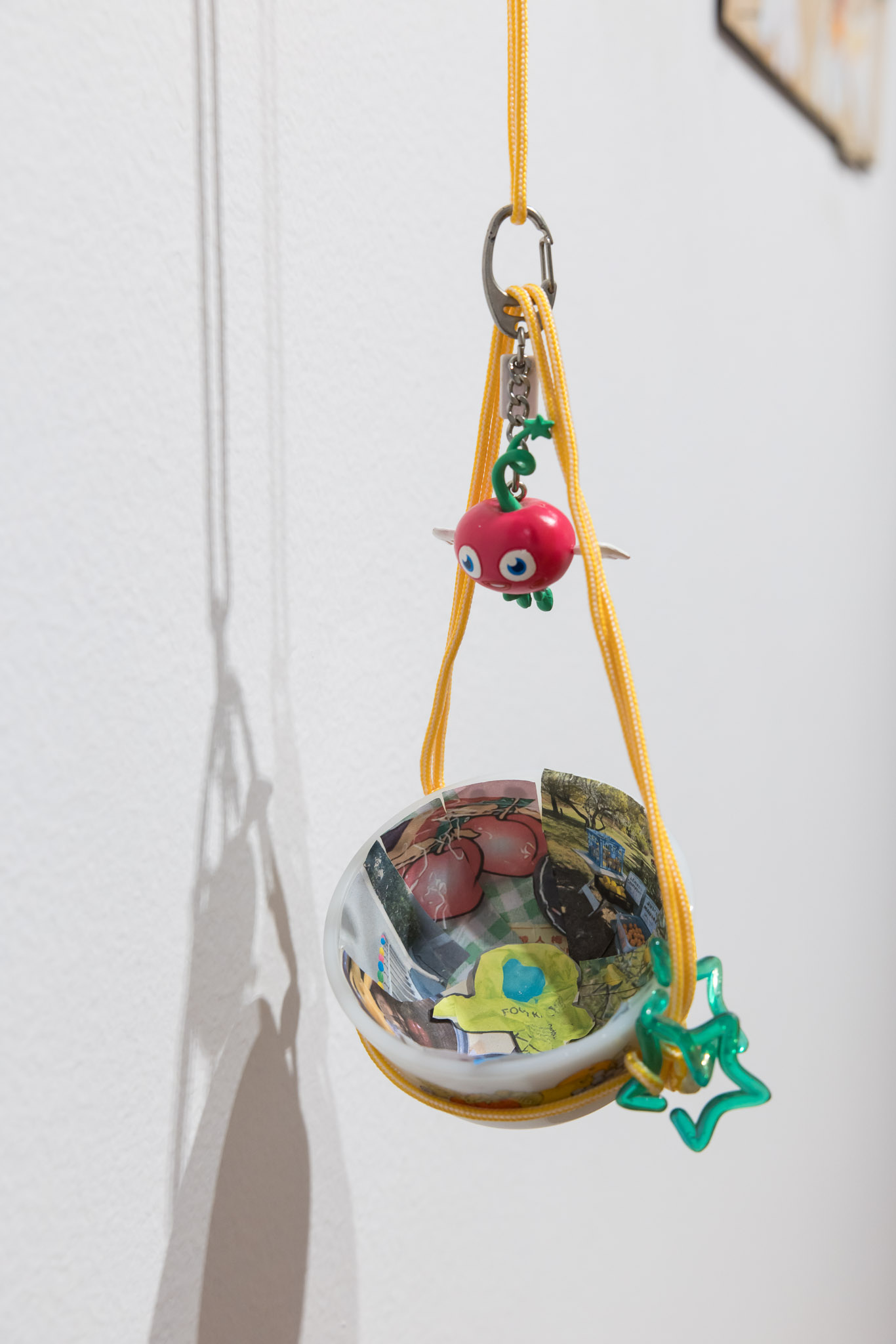 'Fruit Bag?', 2025. Images on paper, objects and paracord