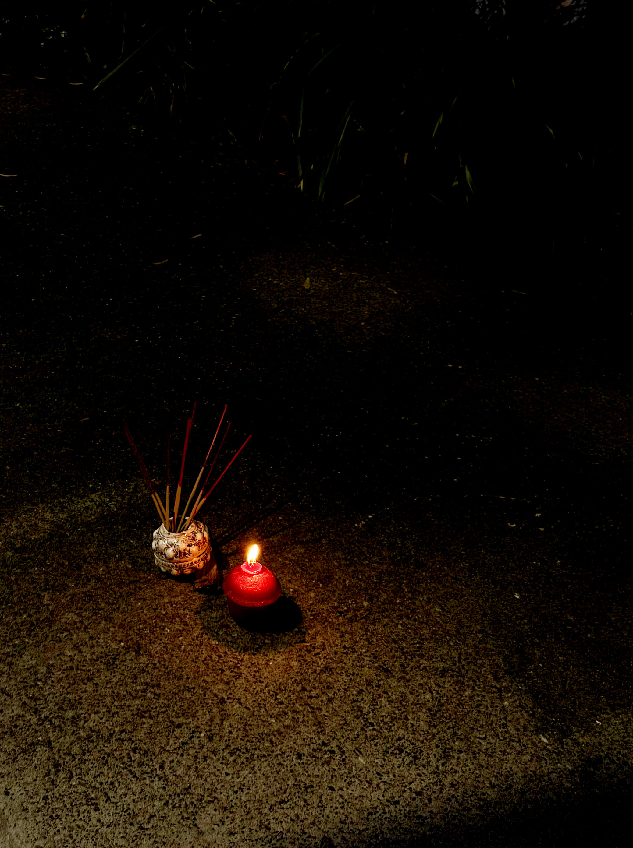 'meld into the shape of mother's motherland', 2025. Wax, lamp wick, slip clay, manganese oxide, satin white glaze, found wood