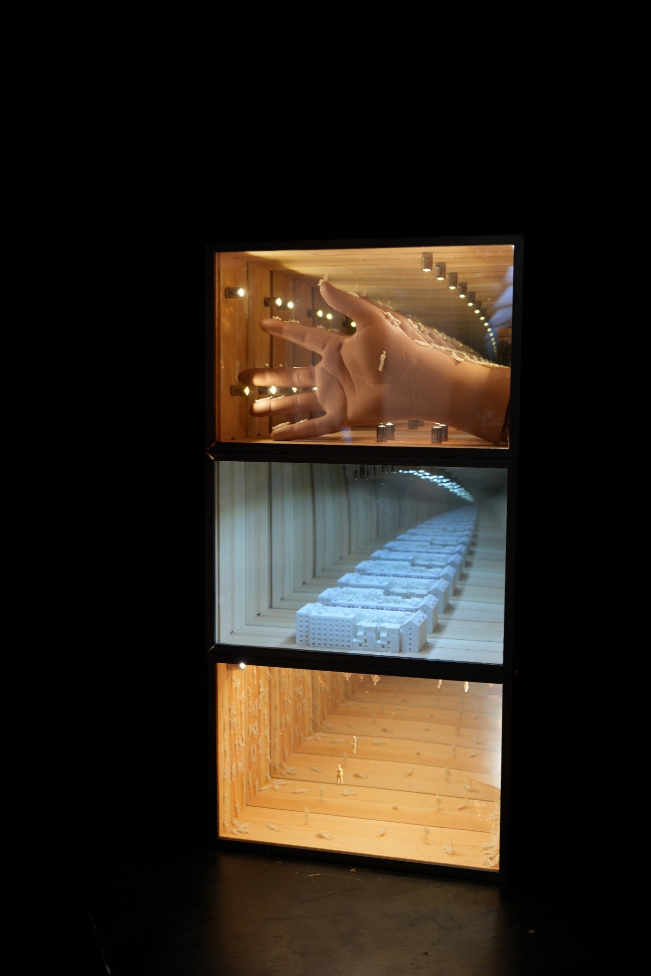 'Loop: Replaying Your Fate Inside', 2025. Mirrored acrylic (two-way), glass mirror, wood box, plastic model hand, miniature figures, 3D-printed PLA parts, coin-cell button lights.
