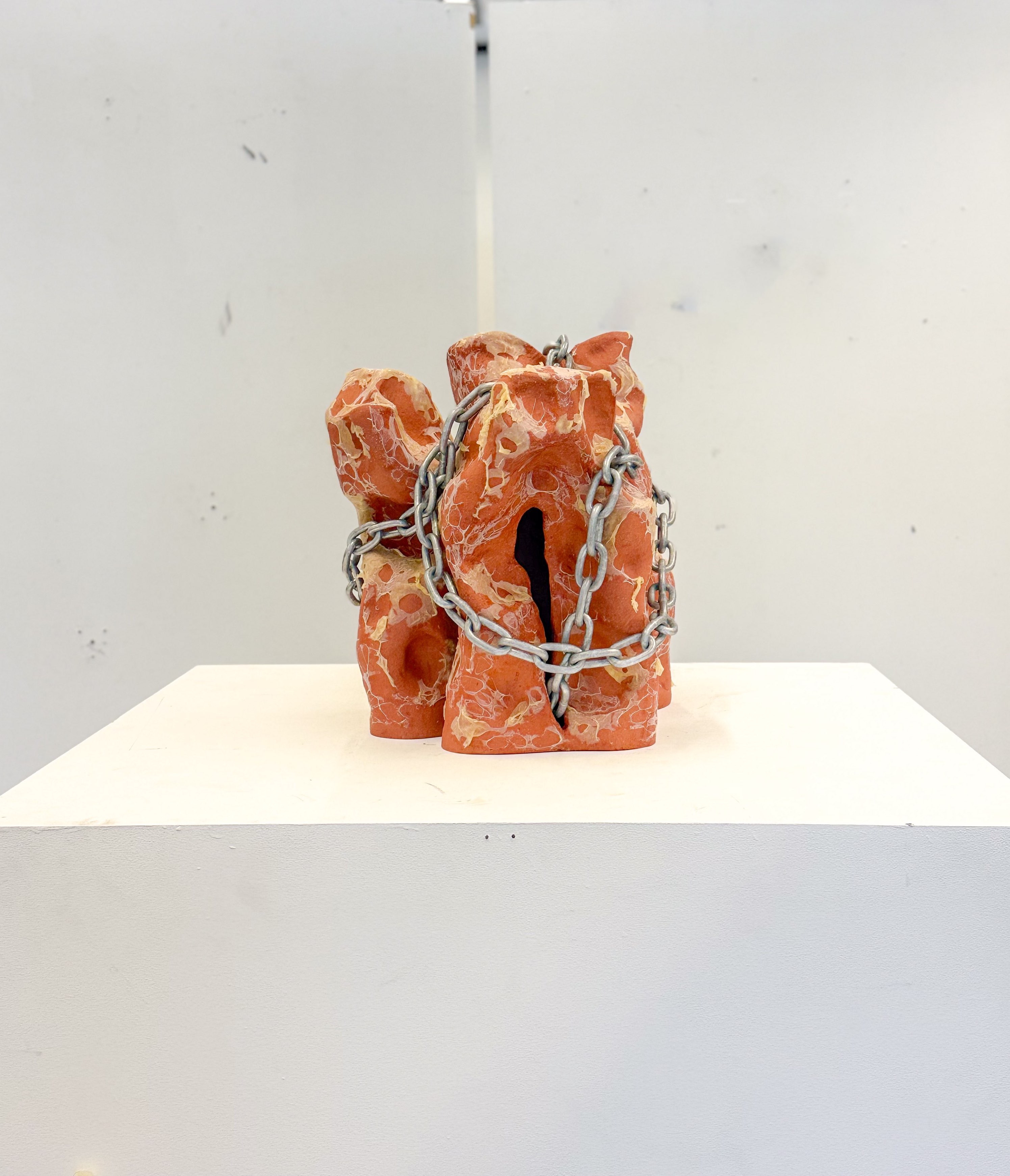 'Can I bite your tongue?', 2025. Earthenware, latex, chain