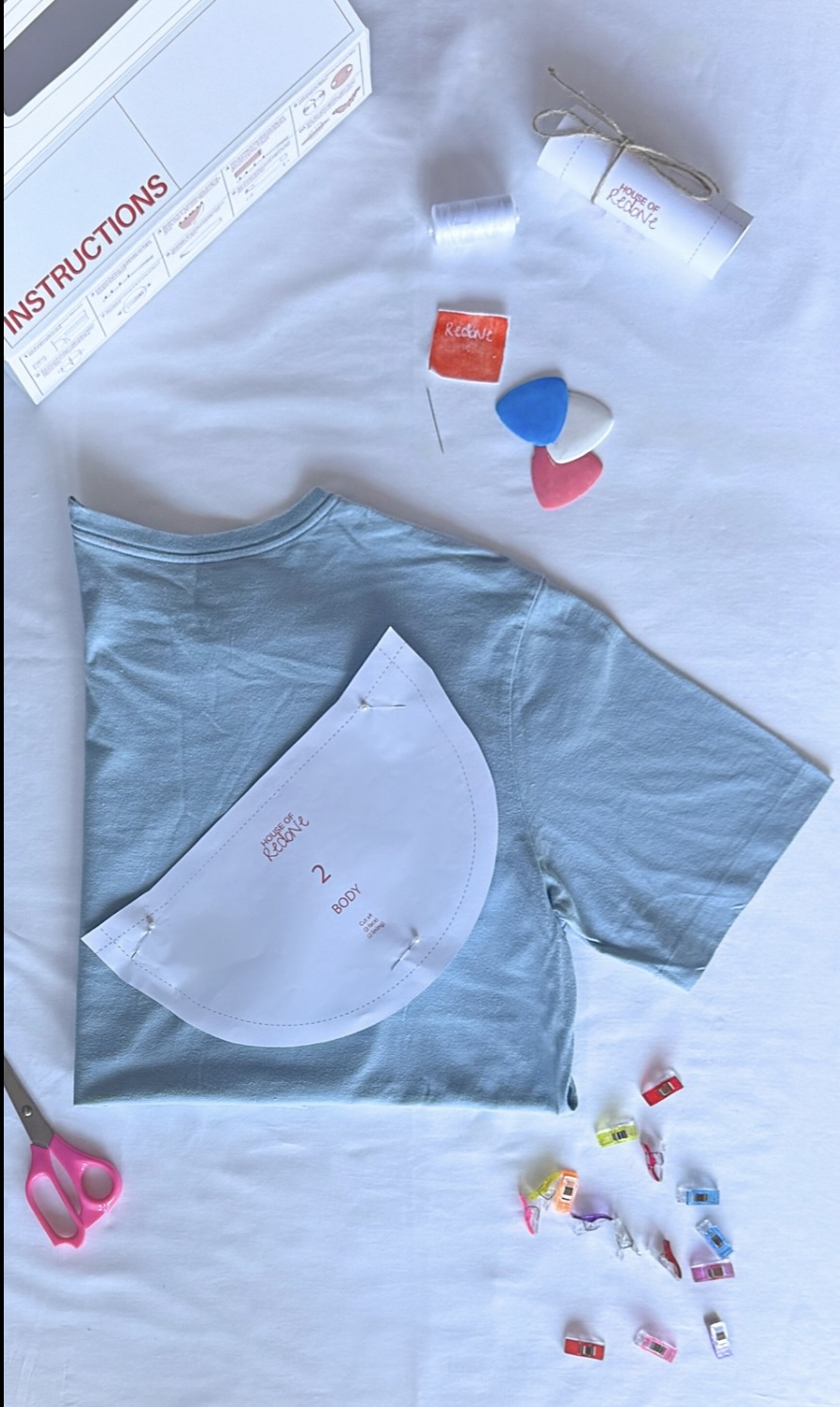 'House of Redone, a series of Textiles DIY Renovation Kits', 2025. Fabric chalk, needle, pattern pieces, pins, recyclable paper (packaging), redone label, seam ripper, sewing clips, thread