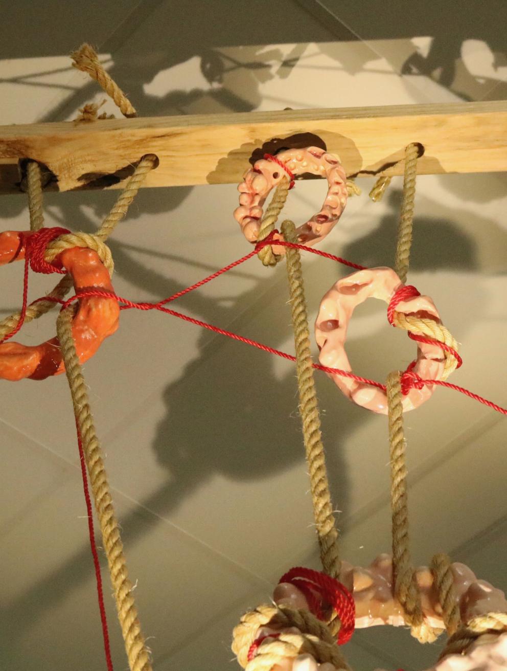 'Fleshscape', 2025. Glazed earthenware, rope, timber
