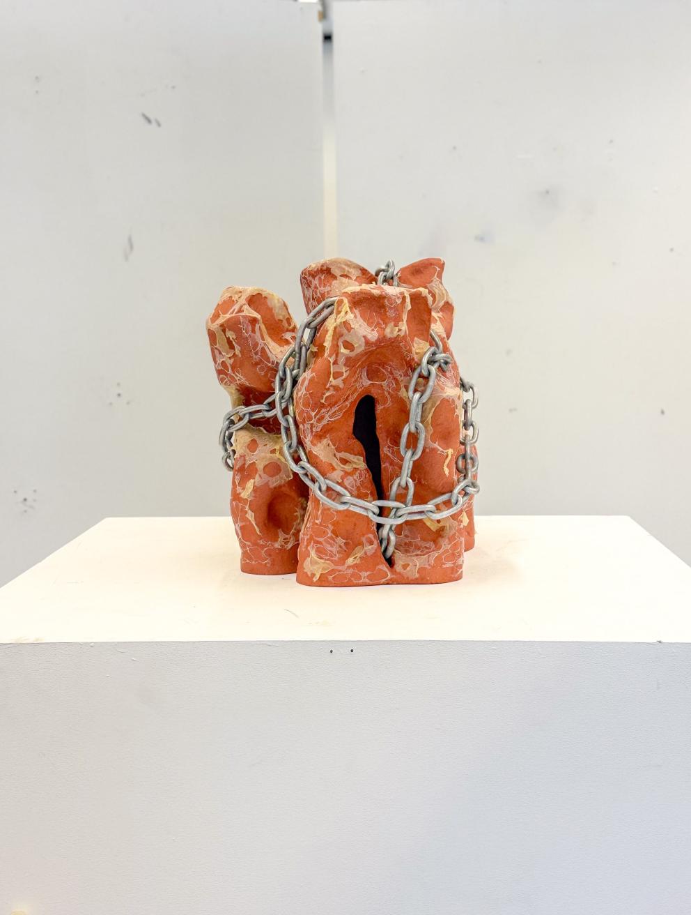 'Can I bite your tongue?', 2025. Earthenware, latex, chain