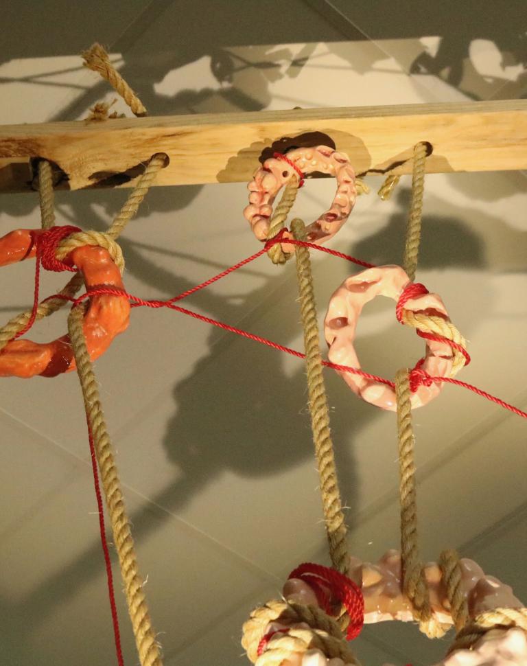 'Fleshscape', 2025. Glazed earthenware, rope, timber