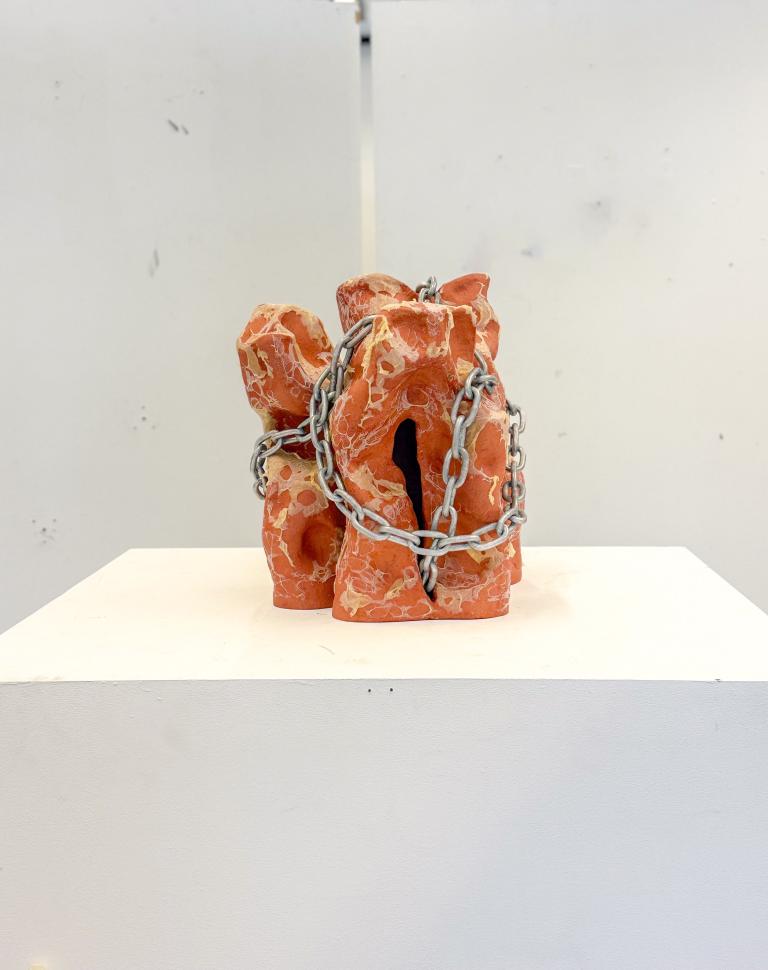 'Can I bite your tongue?', 2025. Earthenware, latex, chain