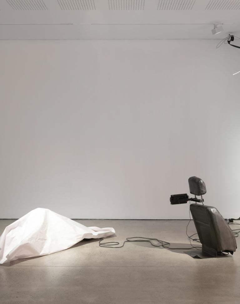  'Passenger Princess', 2025. Installation, video, steel, bitumen, paper, seat belts, electric motor.